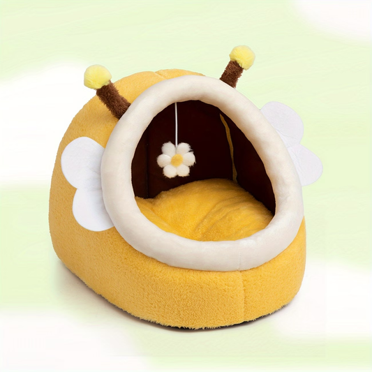 A cozy bee-themed cat bed with hanging toys