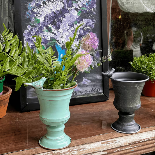 A vintage wrought iron flower pot for the patio, shaped like a bird.